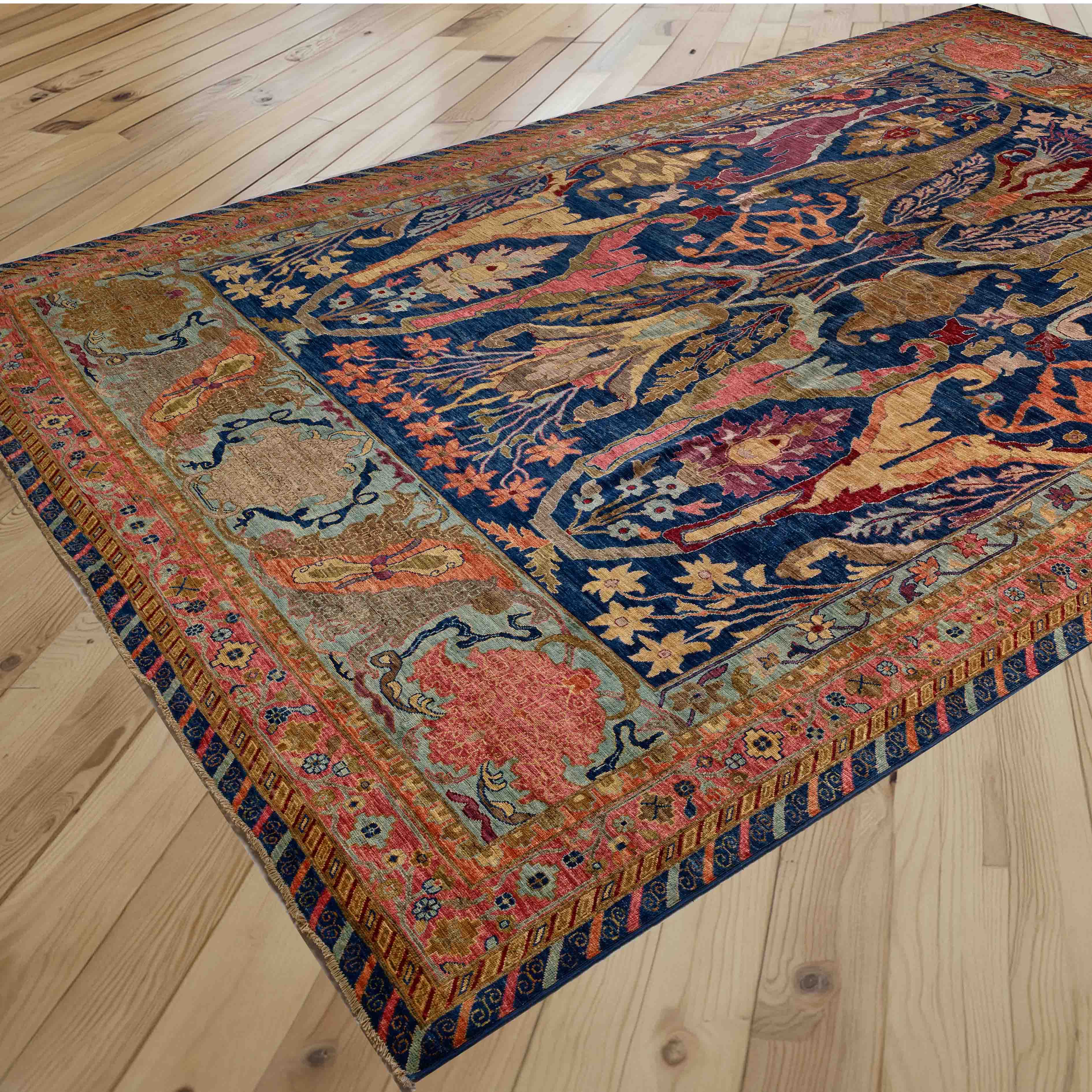 A colourful rectangular vintage-style area rug with an intricate floral pattern is shown laid out on a light-colored wooden floor.