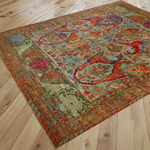 A rectangular vintage-style area rug with a botanical multicolour floral pattern combining forest green, olive green and aqua green with papaya, azure blue, crimson and mocha.  