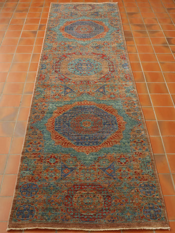 The medallions go through the length of the runner, with the middle one having a red edging, followed by two bold turquoise and deep blue medallions that just sing out from the background.  The background colour is a soft fawn shade with all of the decoration being executed in red, turquoise, and deep blue. 