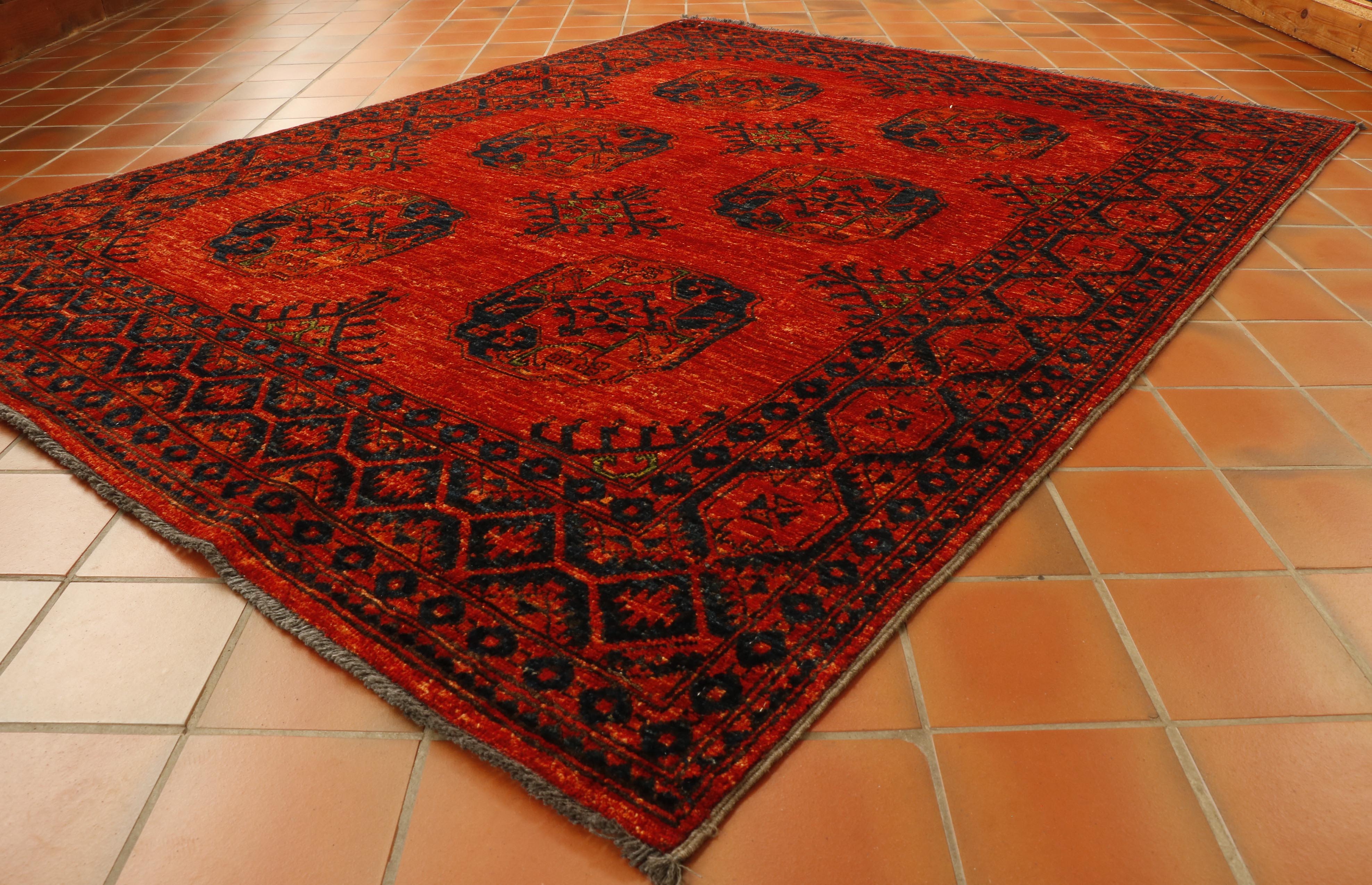 Strong burnt orange ground through the entirety of this rug.  The 6 motifs and the broad border uses a deep blue with bright green highlights.