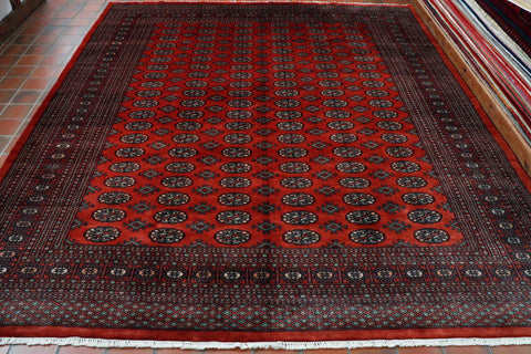 This Bokhara has a rich red ground with bands of stylized flowers, 6 bands in total across the length of the piece.   These are outlined in very dark blue/black with the inner pattern uses a soft peach, soft duck egg blue/green and cream as highlights.   There is a broad band of border, made up of several different width sized areas of smaller border using the same colour palette.  These are decorated in small and large flower designs and the broader outer border being a trellis decoration. 